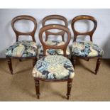 Four Victorian mahogany balloon-back dining chairs.