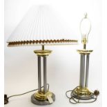 A pair of contemporary gilt and white metal table lamps.