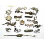 A selection of silver and other brooches,