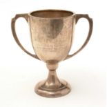 A silver two-handled trophy cup.