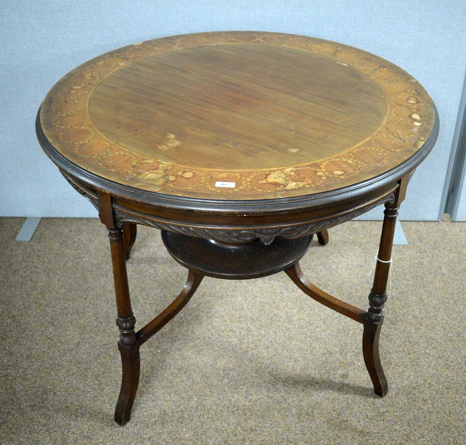 An Edwardian inlaid mahogany centre table.