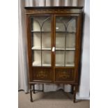 An Edwardian mahogany and line inlaid display cabinet.