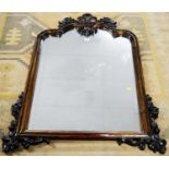 An ornate Victorian-style hardwood mirror.