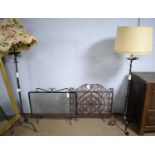 Two vintage spark guards; and two wrought iron lamp standards.