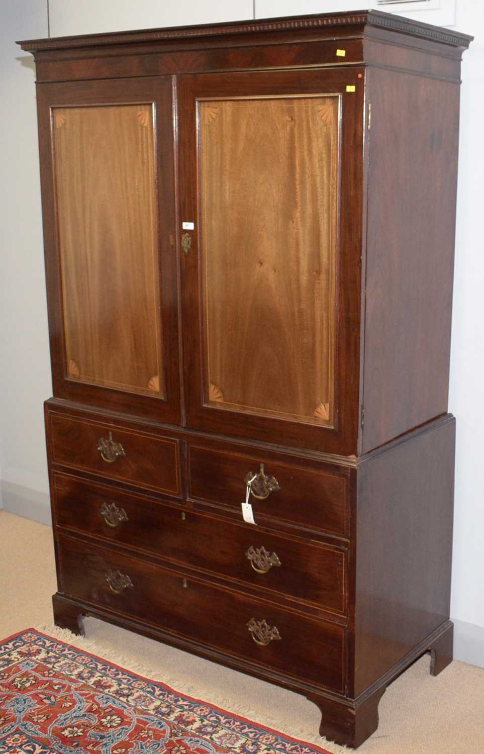 An inlaid mahogany clothes press.