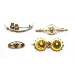 A crescent brooch, and three other brooches