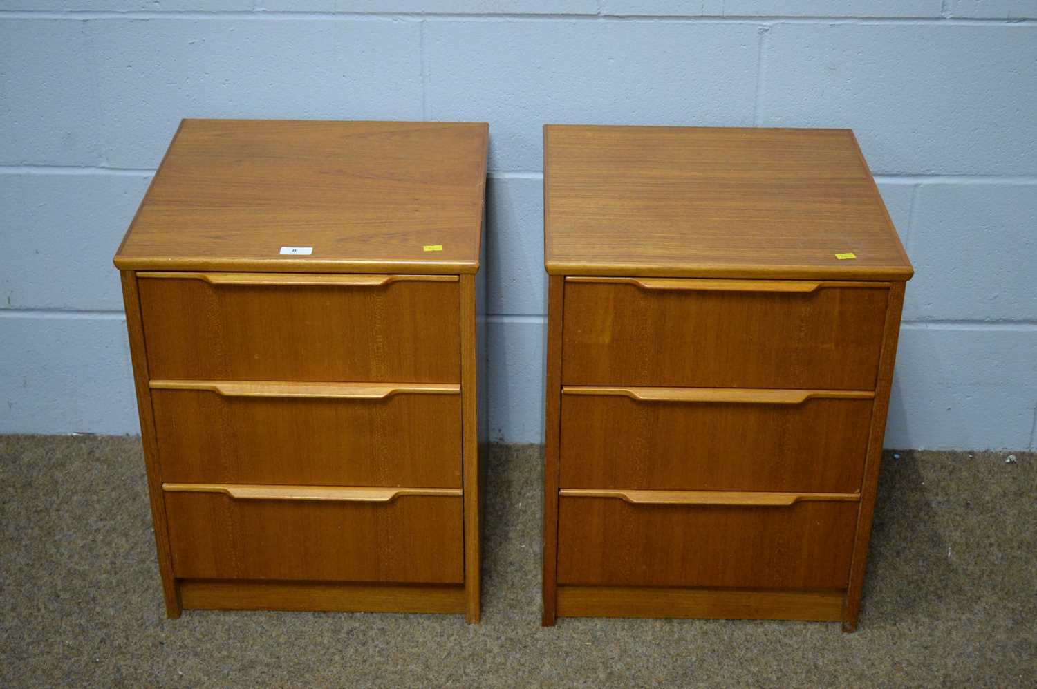 A pair of mid Century teak veneered bedside chests.