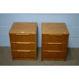 A pair of mid Century teak veneered bedside chests.