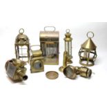 A selection of Victorian and later brass travel lamps; and a pin dish