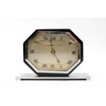 An Art Deco chrome and ebonised wood mantle clock