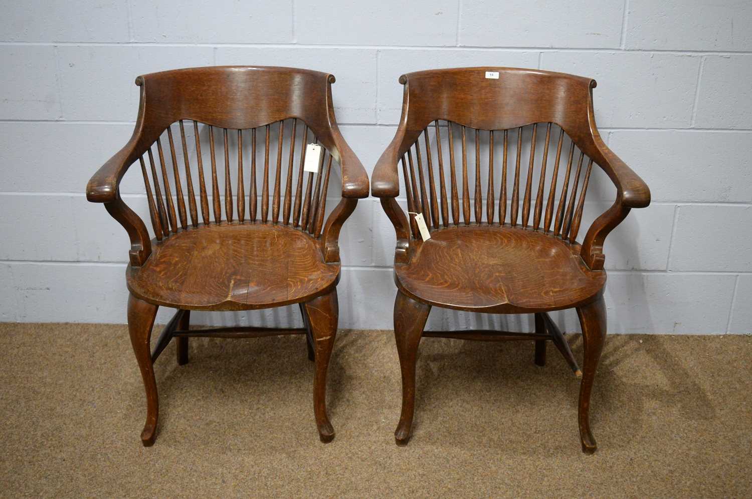 A pair of early 20th Century oak bow-back smokers chairs.