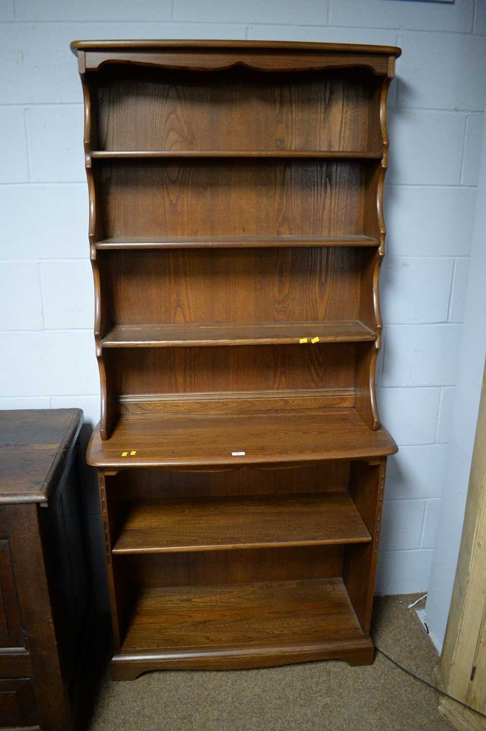 Ercol: a large elm open bookcase.