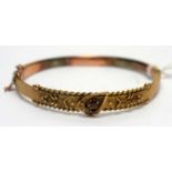 A 9ct yellow gold buckle pattern bangle,