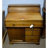 An unusual early 20th Century mahogany roll and folding top desk.