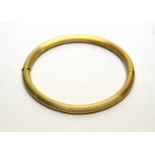 An 18ct yellow gold bangle,