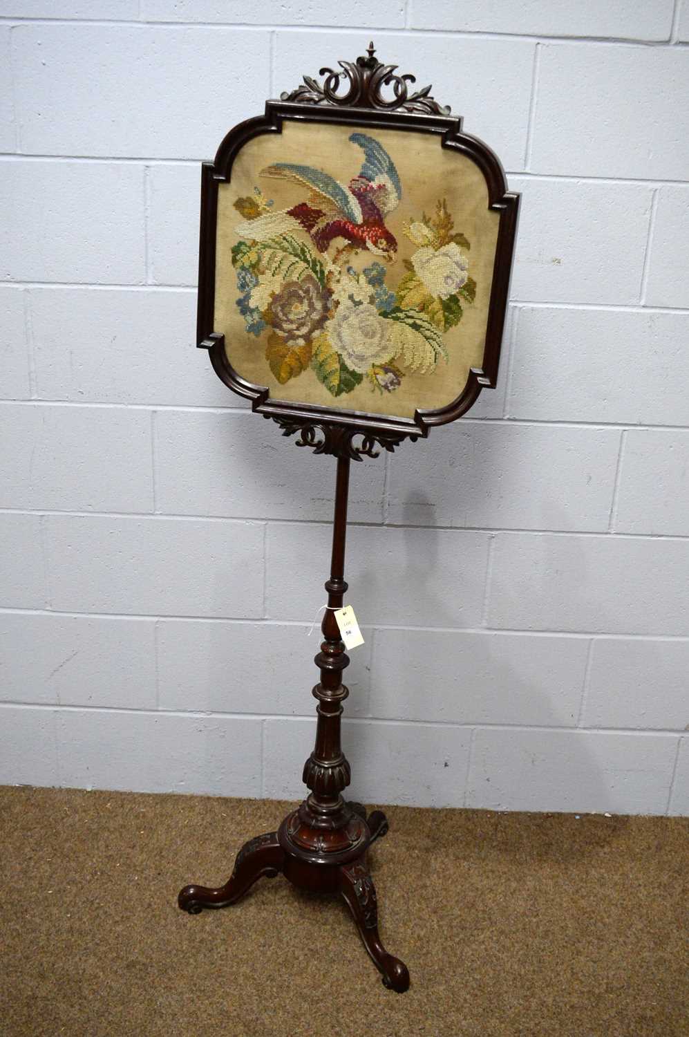 An ornate Victorian carved mahogany pole screen.