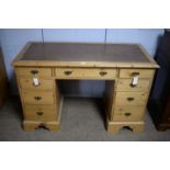 A stripped pine pedestal desk.