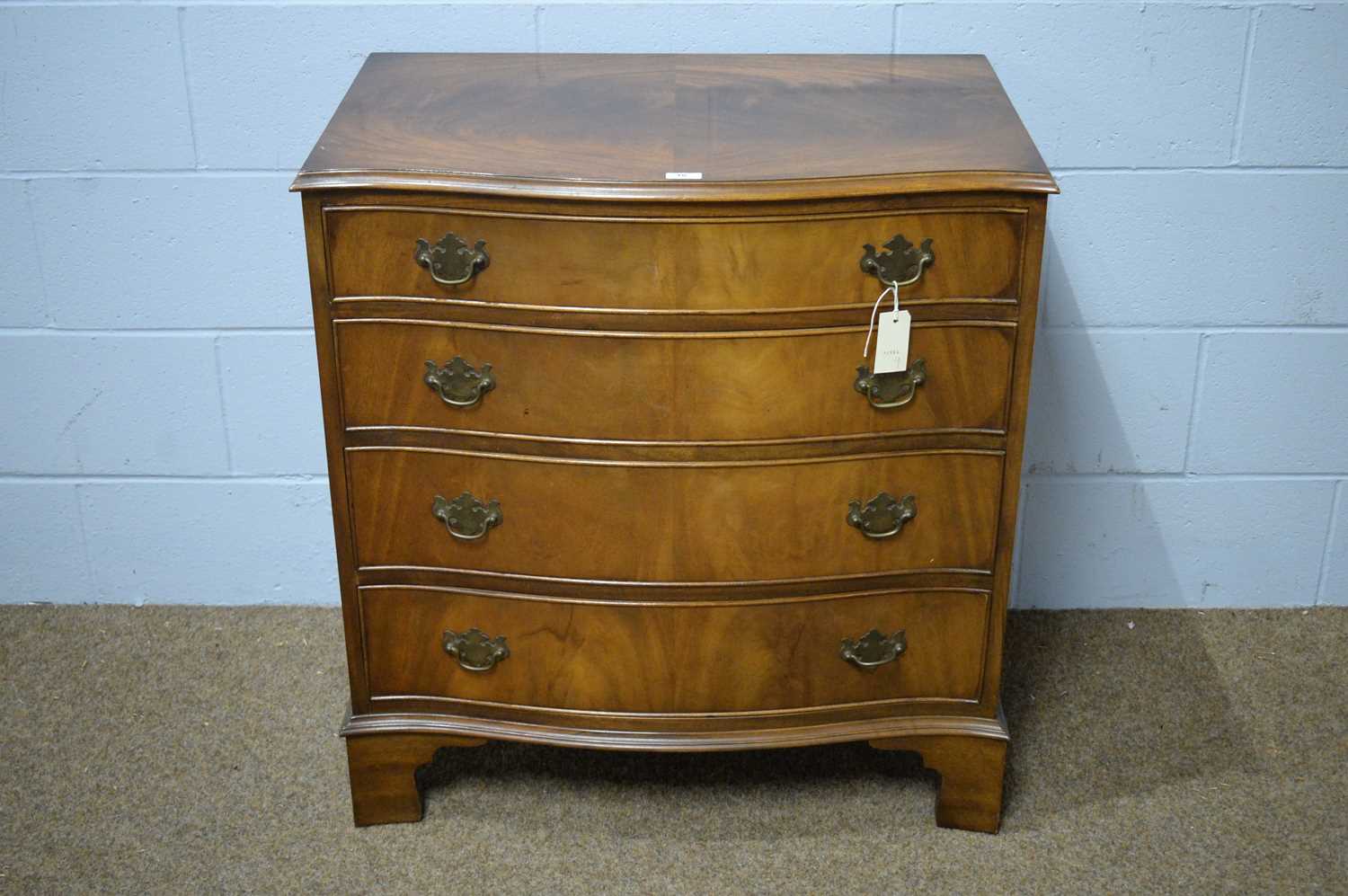 A Georgian-style reproduction serpentine chest.