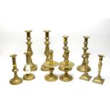 A collection of five sets of Victorian brass candlesticks