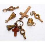 A selection of gold and other charms and watch keys.