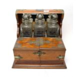 An early 20th Century three bottle tantalus
