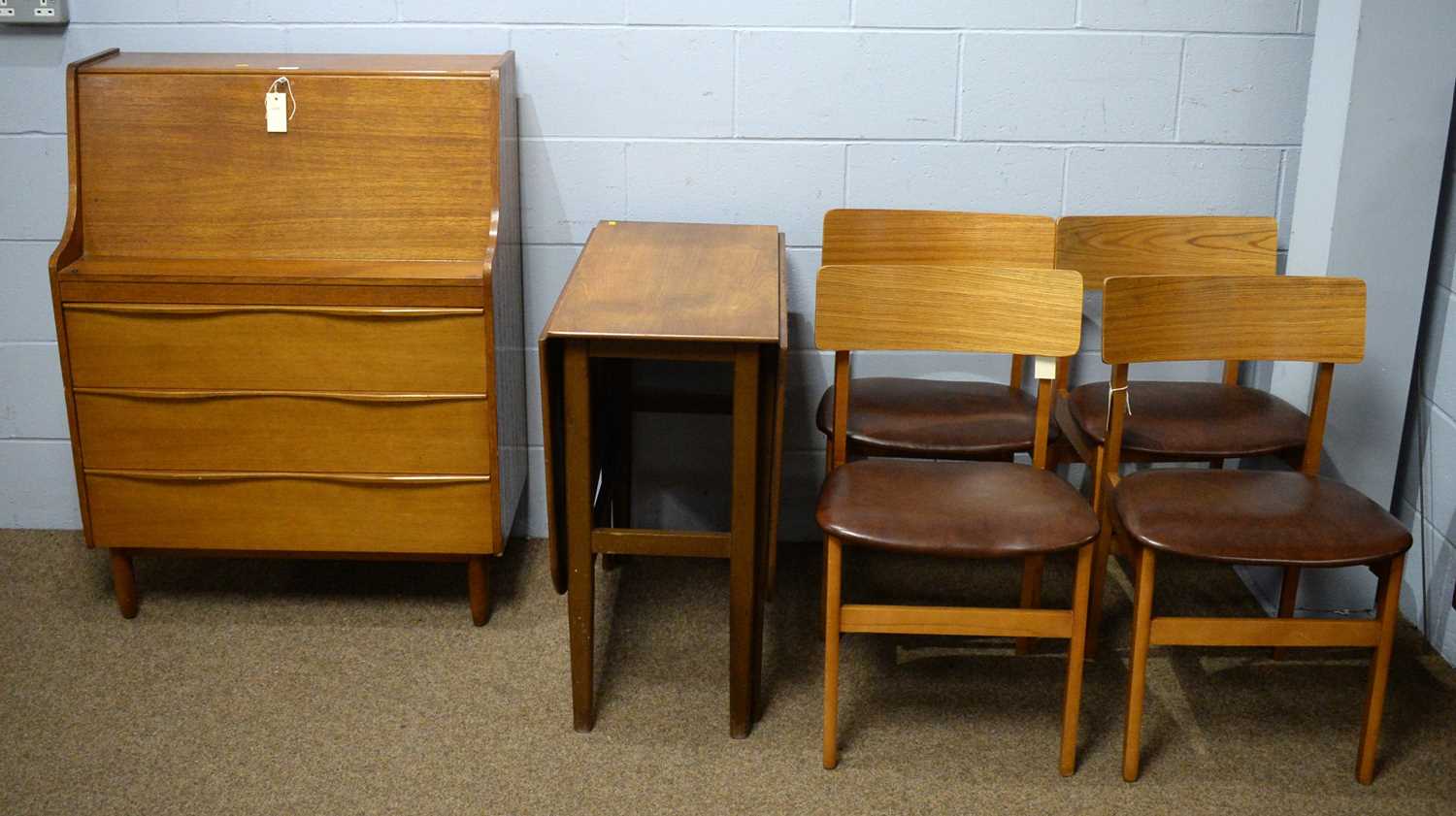 Mid Century teak writing bureau; dining table; and four chairs.