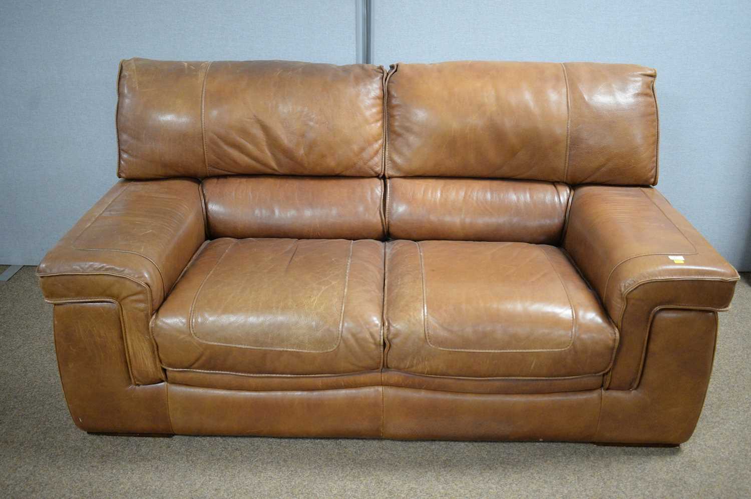 Land of Leather: a modern brown leather two-seater sofa.