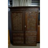 A profusely carved oak wardrobe, basically Georgian with later Victorian carving.