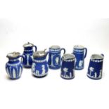 Seven Ridgway dark-blue Jasperware jugs.