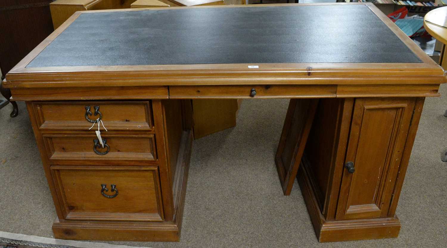 A modern stained pine pedestal desk