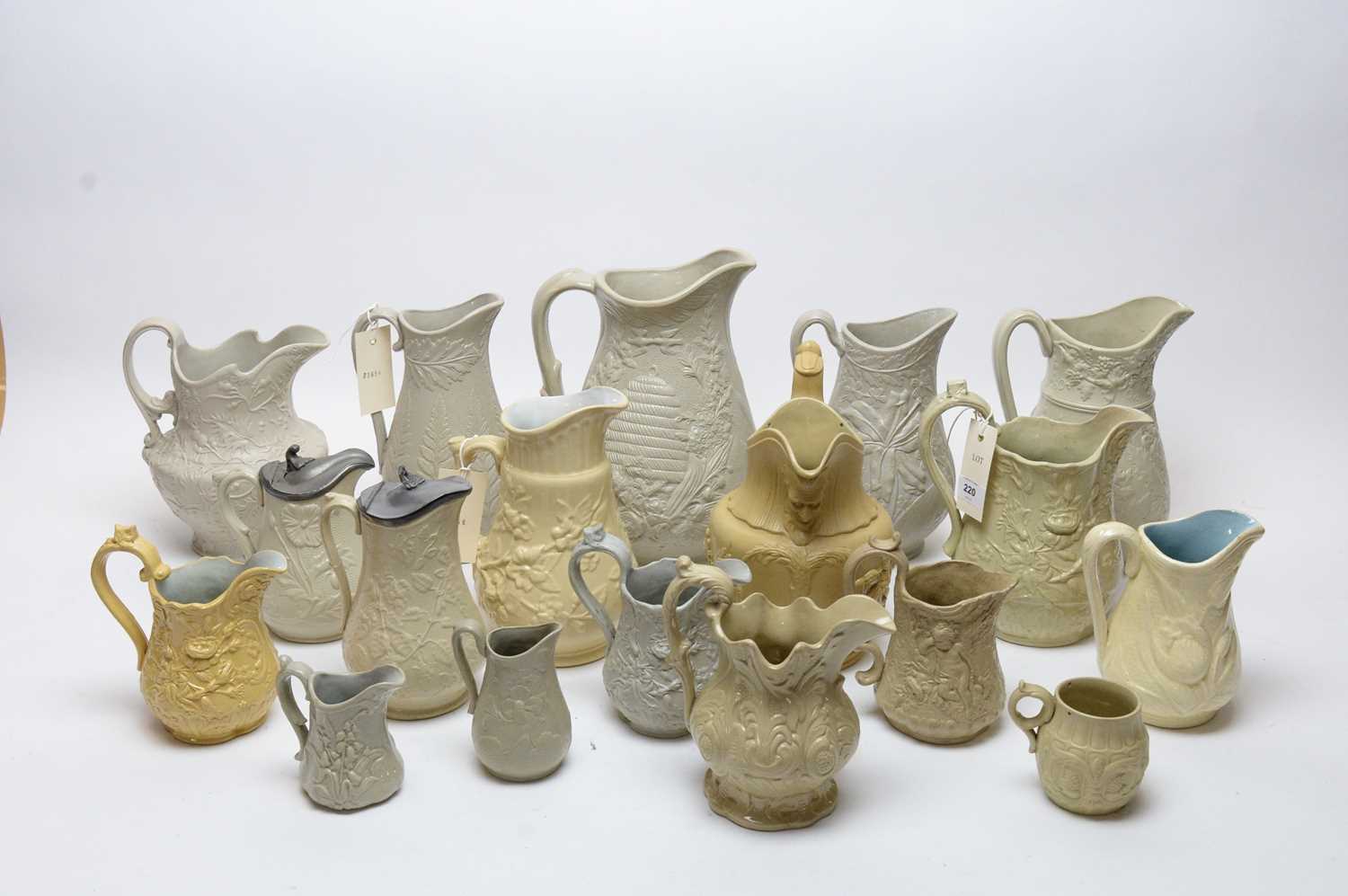 A selection of Dudson and Ridgway buff-coloured moulded stoneware jugs.