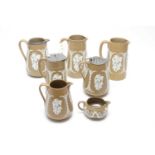 Seven 19th Century Ridgway buff stoneware sprig jugs.