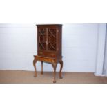 A Georgian-style mahogany cabinet on stand.