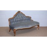 A Victorian carved walnut button back settee.
