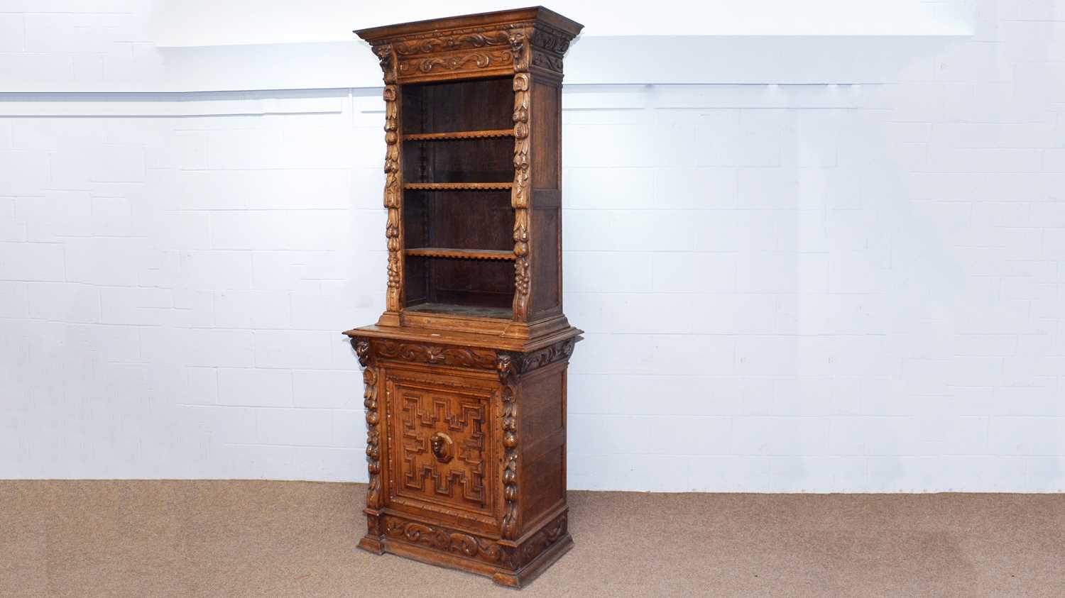 A profusely carved North European 19th C oak bookcase cabinet.