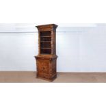 A profusely carved North European 19th C oak bookcase cabinet.