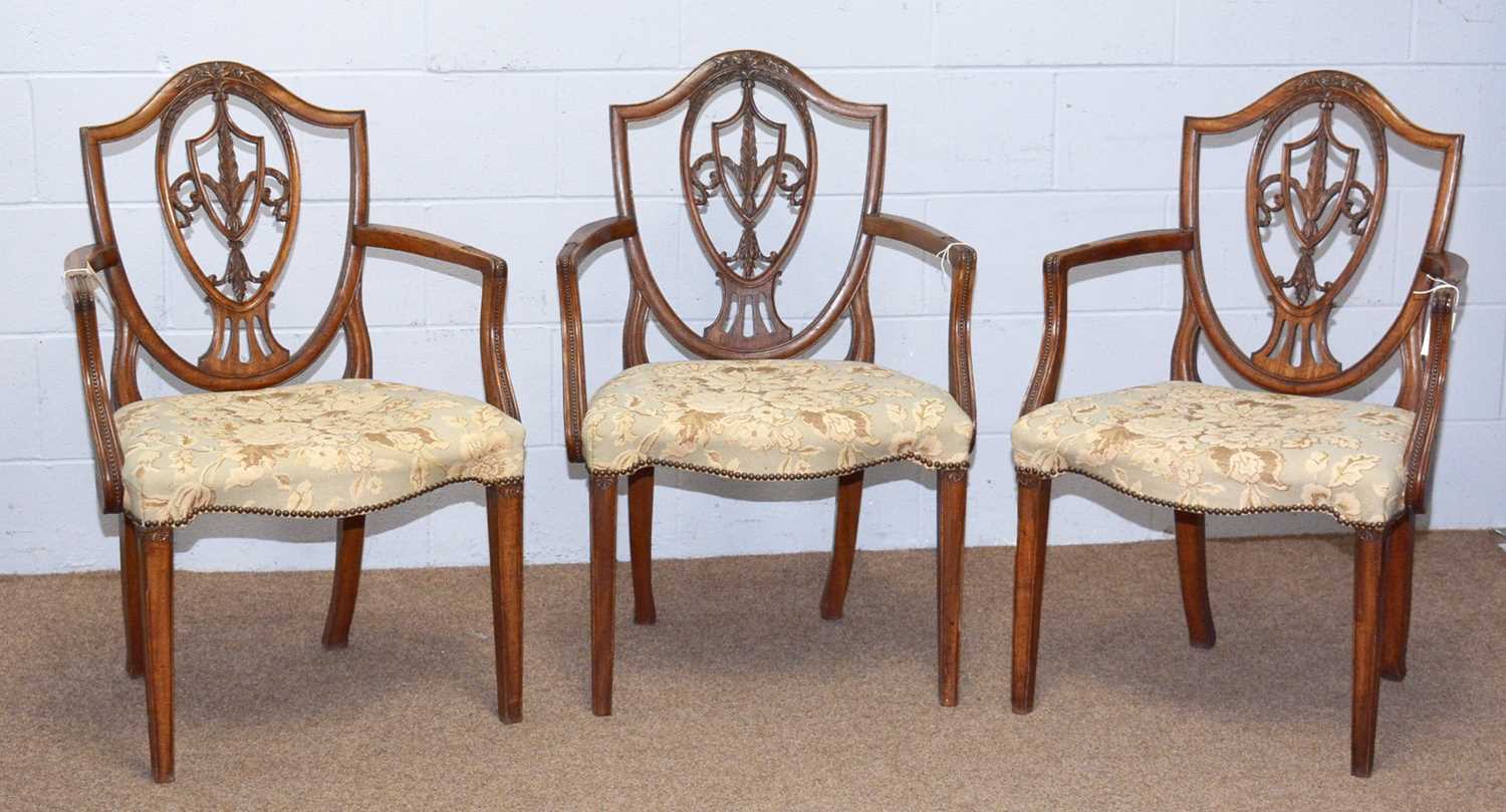 Three 19th Century Hepplewhite-style mahogany elbow chairs.