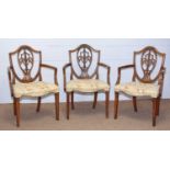 Three 19th Century Hepplewhite-style mahogany elbow chairs.