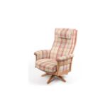 Ercol: an elm electric reclining and swivel armchair.