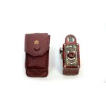 A Coronet 'Midget' red bakelite miniature camera