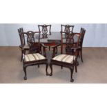 An early 20th C mahogany extending dining table; and eight chairs.