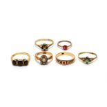 A three stone garnet ring, and five other rings.
