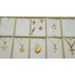 A selection of 9ct yellow gold pendants and charms,