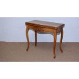 A late 19th Century figured walnut and serpentine fronted card table.