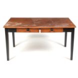 A mid Century oak and ebonised desk.