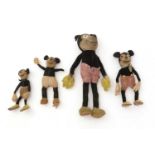 Four Walt Disney Productions Mickey Mouse felt-topped toys.