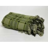 A traditional Welsh large woven blanket in moss green