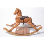 A carved and varnished pine rocking horse,