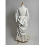 A late 1960s Laura Ashley "Victorian Revival" ivory seersucker bustle dress