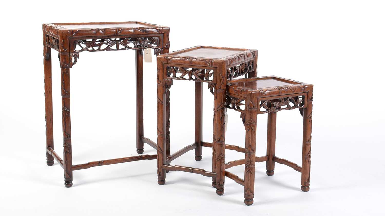 A nest of three Chinese carved huanghuali occasional tables